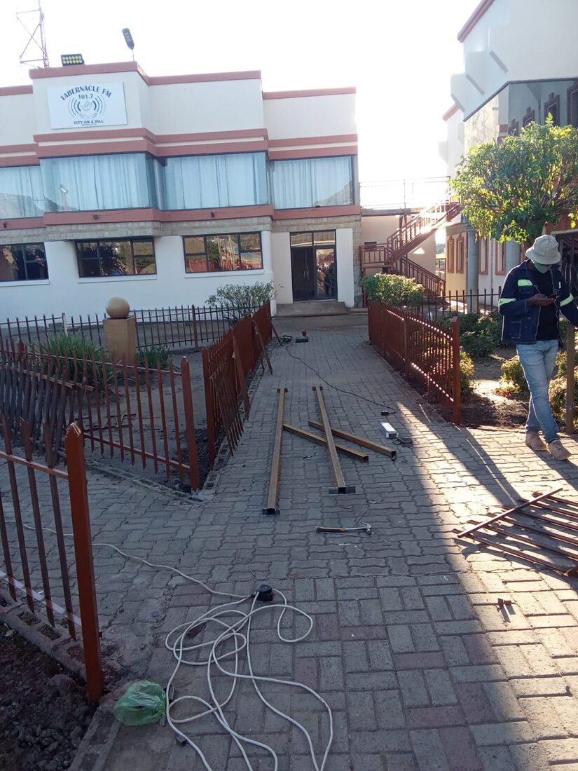 Steel palisade fencing installed along a paved walkway
